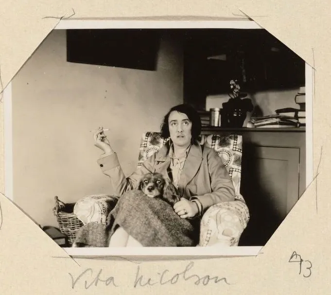 Album snapshot of Vita Sackville-West seated with her spaniel