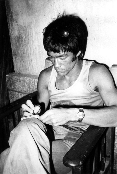 Bruce Lee writing in his Journal. Location: Unknown. 