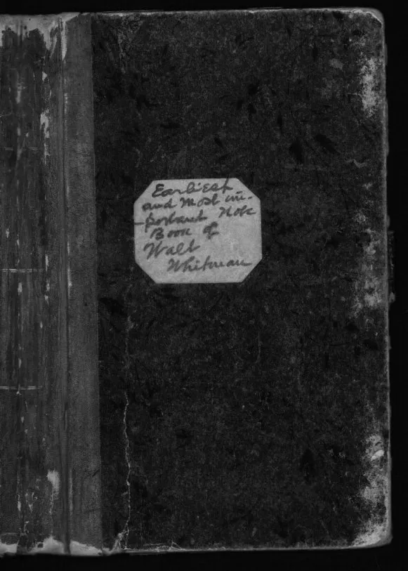 Dark worn cover of Whitman's earliest surviving notebook with a small octagonal label pasted on it